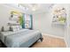 Cozy bedroom with hardwood floors, ample shelving, and natural light from the window at 101 Sweetwater Oaks Ln, Daytona Beach, FL 32114