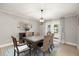 Elegant dining room with a glass table, woven chairs, and natural light from the patio doors at 101 Sweetwater Oaks Ln, Daytona Beach, FL 32114