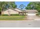 Charming single-story home with a well-manicured lawn and a two-car garage at 101 Sweetwater Oaks Ln, Daytona Beach, FL 32114