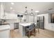 Bright kitchen with white cabinets, a center island, and stainless steel appliances at 101 Sweetwater Oaks Ln, Daytona Beach, FL 32114