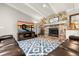 Cozy living room featuring a stone fireplace, comfortable seating, and a large TV at 101 Sweetwater Oaks Ln, Daytona Beach, FL 32114