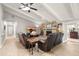 Inviting living room boasts stone fireplace, wood floors, and leather seating at 101 Sweetwater Oaks Ln, Daytona Beach, FL 32114