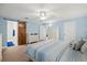 A lovely bedroom boasts wood-look floors, a ceiling fan, and a rustic sliding barn door at 101 Sweetwater Oaks Ln, Daytona Beach, FL 32114