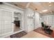 Bright office space featuring custom built-ins, wood-look ceilings, and a view to the living room at 101 Sweetwater Oaks Ln, Daytona Beach, FL 32114