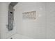 Modern shower featuring white subway tile, a rain shower head, and a built-in niche at 101 Sweetwater Oaks Ln, Daytona Beach, FL 32114