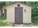 This storage shed has a classic design with a brown door and exterior light at 101 Sweetwater Oaks Ln, Daytona Beach, FL 32114