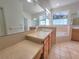 This primary bathroom features double sinks, a large soaking tub, a walk-in shower and bright natural light at 1072 Ceasars Ct, Mount Dora, FL 32757