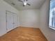 Cozy bedroom with wood flooring, double door closet and large bright window at 1072 Ceasars Ct, Mount Dora, FL 32757