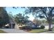 Well-maintained single-Gathering home featuring lush landscaping and a charming stone facade at 1072 Ceasars Ct, Mount Dora, FL 32757