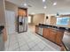 An updated kitchen with stainless steel appliances, tile floors, and ample cabinet space at 1072 Ceasars Ct, Mount Dora, FL 32757