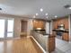 Modern kitchen with black countertops, wood cabinets, and stainless-steel appliances at 1072 Ceasars Ct, Mount Dora, FL 32757