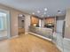 An open-concept kitchen featuring stainless steel appliances and a breakfast bar with tiled accents at 1072 Ceasars Ct, Mount Dora, FL 32757