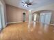 Bright, open living room features hardwood floors, ceiling fan, and archways leading to other rooms at 1072 Ceasars Ct, Mount Dora, FL 32757