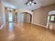 Spacious living room boasts hardwood floors and is naturally lit with archways at 1072 Ceasars Ct, Mount Dora, FL 32757