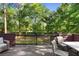 Back deck with seating overlooking the fenced backyard at 1081 Torchwood Dr, Deland, FL 32724