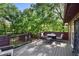 Back deck with seating and a view of the tree lined yard at 1081 Torchwood Dr, Deland, FL 32724