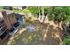 Overhead shot of the backyard, featuring a fire pit, ample seating, and lush trees for privacy at 1081 Torchwood Dr, Deland, FL 32724