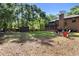 Lush backyard features a storage shed, a firepit, and green space at 1081 Torchwood Dr, Deland, FL 32724