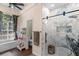 Bright bathroom featuring glass shower, marble details, and built-in shelves at 1081 Torchwood Dr, Deland, FL 32724