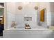 Sunlit bathroom with a white tiled bathtub, gold fixtures, niche, and decor creating a relaxing atmosphere at 1081 Torchwood Dr, Deland, FL 32724