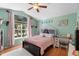 Charming bedroom with a vaulted ceiling, large window, and unique decor at 1081 Torchwood Dr, Deland, FL 32724