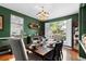 Formal dining room with hardwood floors, a decorative chandelier, and a dark wood table with seating for six at 1081 Torchwood Dr, Deland, FL 32724