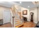 Foyer with a wooden staircase and decor at 1081 Torchwood Dr, Deland, FL 32724