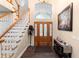 Welcoming foyer with hardwood floors, staircase, and a decorative front door at 1081 Torchwood Dr, Deland, FL 32724