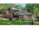 Beautiful two-story brick home with well-maintained landscaping and charming curb appeal in a wooded area at 1081 Torchwood Dr, Deland, FL 32724
