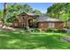 Charming two-story brick home with a well-manicured lawn and mature trees at 1081 Torchwood Dr, Deland, FL 32724