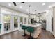 Bright kitchen featuring white cabinets, stainless steel appliances, an island with seating, and hardwood floors at 1081 Torchwood Dr, Deland, FL 32724