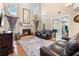 Bright living room with a cozy fireplace, large windows, and comfortable seating at 1081 Torchwood Dr, Deland, FL 32724