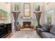 Inviting living room showcasing a fireplace, tall windows, and ample seating at 1081 Torchwood Dr, Deland, FL 32724