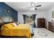 Well-lit primary bedroom featuring hardwood floors, a ceiling fan, and outside backyard access at 1081 Torchwood Dr, Deland, FL 32724
