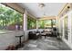 Enclosed patio with tile flooring and neutral furniture offering comfortable outdoor living at 1081 Torchwood Dr, Deland, FL 32724