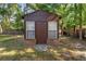 Close up of the exterior of the backyard shed with brick foundation at 1081 Torchwood Dr, Deland, FL 32724