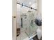 Bathroom with a glass-enclosed shower featuring textured tiling, a rain shower head, and modern fixtures at 1081 Torchwood Dr, Deland, FL 32724