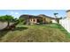 Large backyard featuring a screened lanai, sparkling pool, lush landscaping, and white vinyl fence at 112 Coral Reef Ct, Sanford, FL 32771