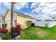 Backyard featuring a well-maintained lawn, fence, and lush landscaping at 112 Coral Reef Ct, Sanford, FL 32771