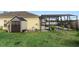 View of the backyard with a shed, screened lanai with pool, and well-kept green grass at 112 Coral Reef Ct, Sanford, FL 32771