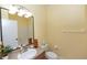 Bright bathroom with a vanity, a sink, a toilet, and a large mirror at 112 Coral Reef Ct, Sanford, FL 32771