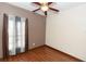 Neutral bedroom featuring wood floors, a ceiling fan, and a window with sheer curtains at 112 Coral Reef Ct, Sanford, FL 32771