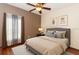 This bedroom features a queen sized bed, wood floors, ceiling fan, and art on the walls at 112 Coral Reef Ct, Sanford, FL 32771