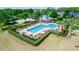 Aerial view of a community pool with lounge chairs and a pavilion, surrounded by lush landscaping at 112 Coral Reef Ct, Sanford, FL 32771