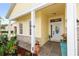 Inviting front porch with decorative plants, stone accents, and a white front door at 112 Coral Reef Ct, Sanford, FL 32771