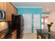 Modern kitchen with stainless steel refrigerator, black countertops, and tile flooring at 112 Coral Reef Ct, Sanford, FL 32771