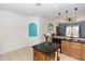 Open kitchen with dark countertops, tile backsplash, and breakfast bar at 112 Coral Reef Ct, Sanford, FL 32771