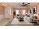 Bright living room featuring a modern ceiling fan, neutral furniture, and stylish decor at 112 Coral Reef Ct, Sanford, FL 32771