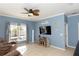 Bright living room with a water view, tile floors, and a ceiling fan at 112 Coral Reef Ct, Sanford, FL 32771