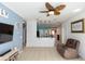 Open-concept living space with a breakfast bar that connects the kitchen and ceiling fan at 112 Coral Reef Ct, Sanford, FL 32771